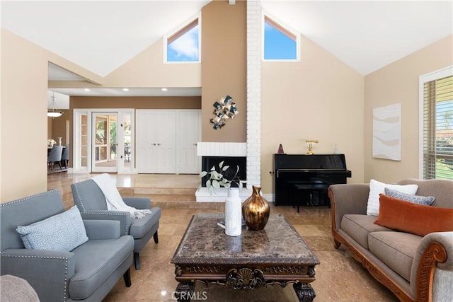 living area with high vaulted ceiling and a brick fireplace