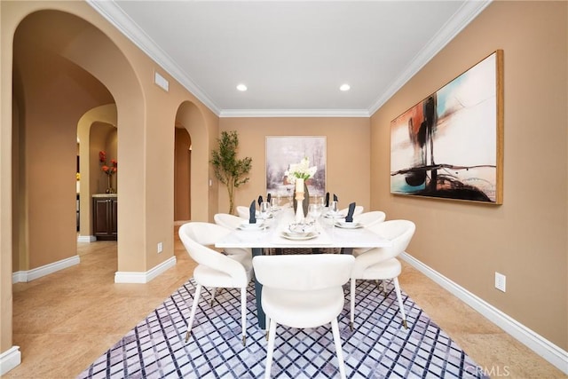 tiled dining area featuring crown molding