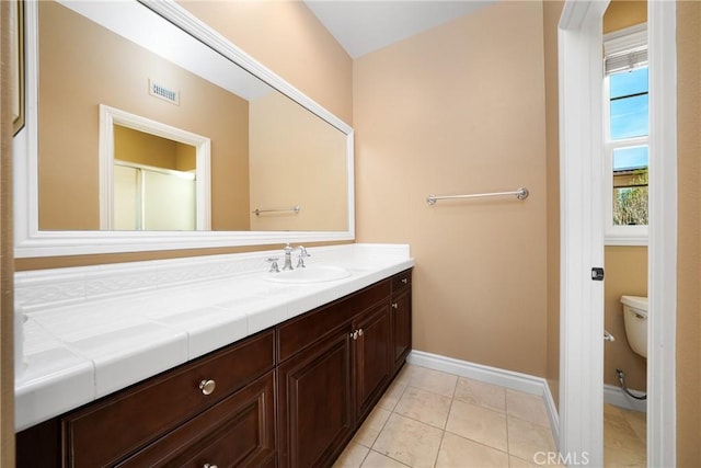 bathroom with tile patterned floors, vanity, and toilet