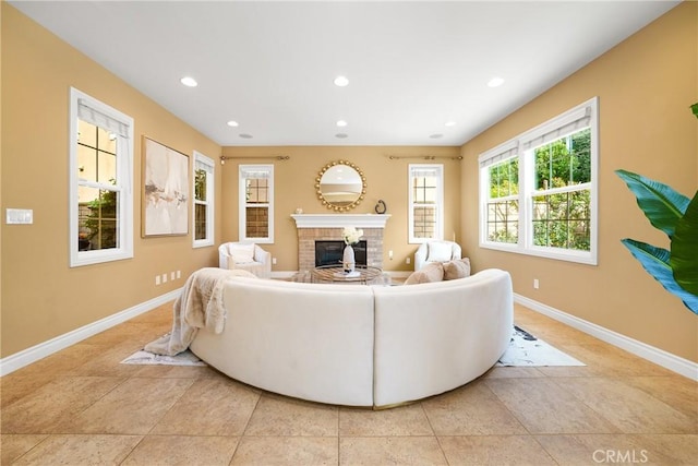 tiled living room featuring a brick fireplace