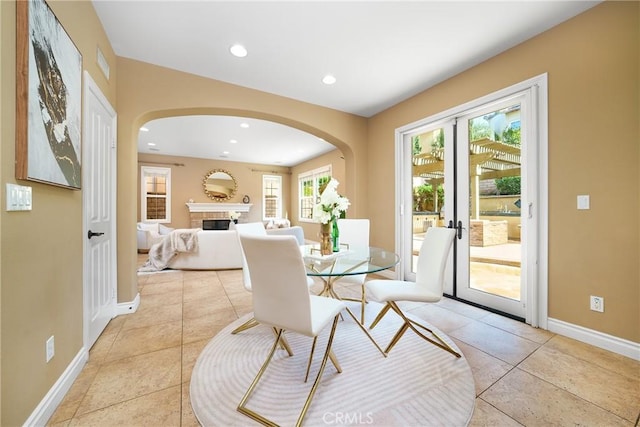 tiled dining area featuring french doors