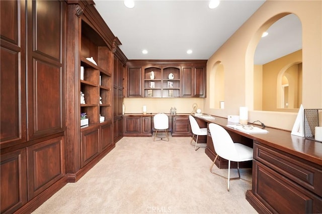 office space featuring light carpet and built in desk