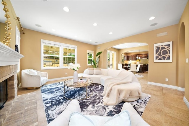 living room with light tile patterned flooring and a fireplace