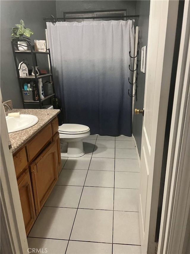 full bath featuring vanity, tile patterned flooring, a shower with curtain, and toilet