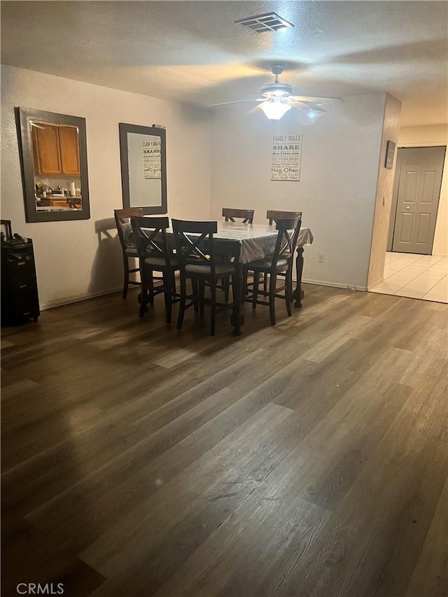 dining room with ceiling fan, dark wood-style flooring, and visible vents