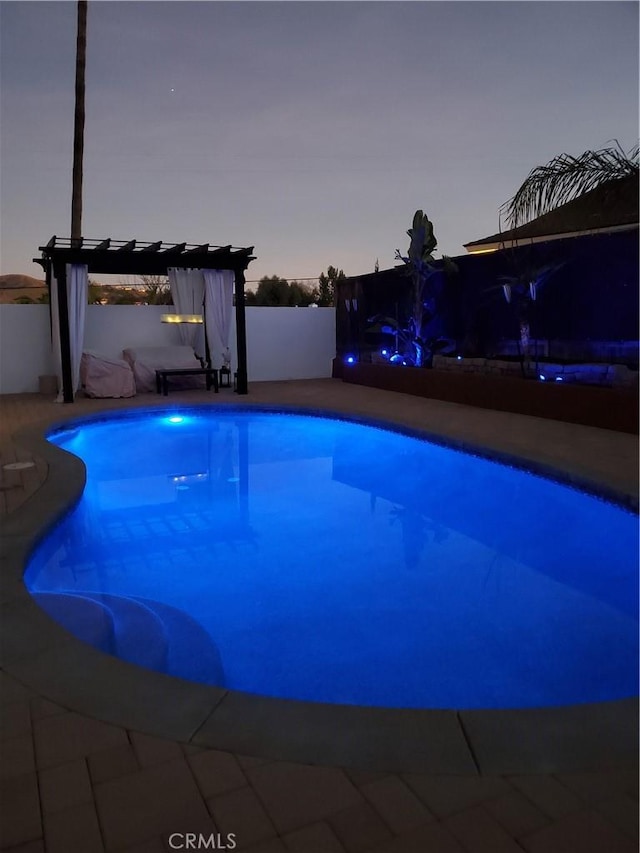 pool at dusk with a fenced in pool, a pergola, a patio, and fence