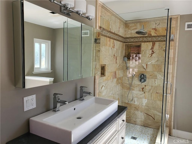 full bathroom featuring vanity, visible vents, and a stall shower