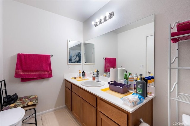 bathroom with tile patterned floors, toilet, and vanity