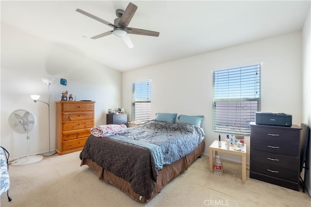 carpeted bedroom with ceiling fan and vaulted ceiling