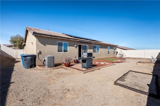 back of property featuring central air condition unit and a patio area