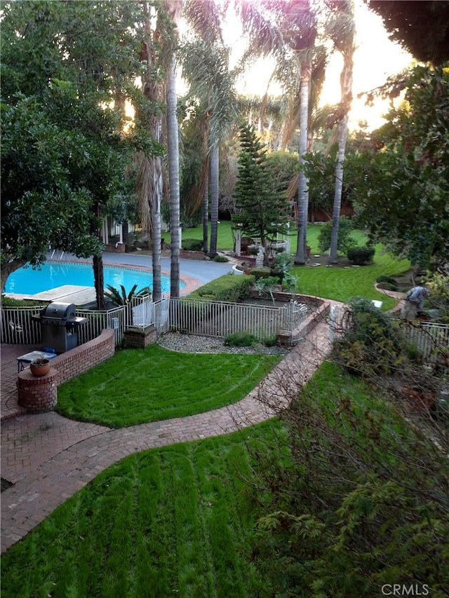 surrounding community featuring a patio area, a yard, and a pool