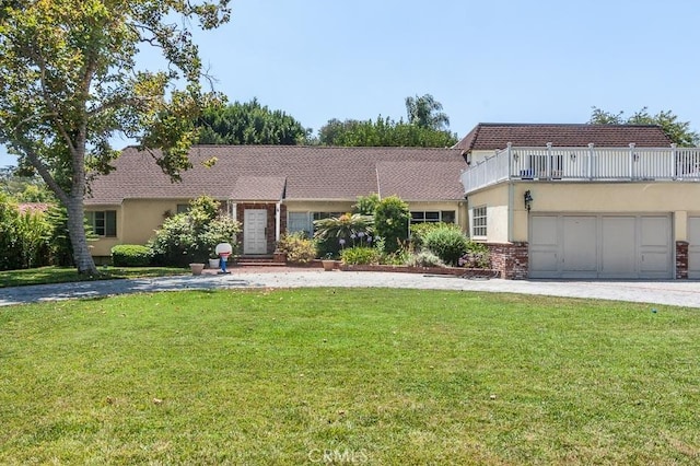 4645 Ledge Ave, Toluca Lake, CA 91602 - view of front of house with a balcony, a front lawn, stucco siding, and driveway
