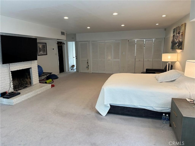 4645 Ledge Ave, Toluca Lake, CA 91602 - bedroom featuring light carpet, a brick fireplace, two closets, and recessed lighting