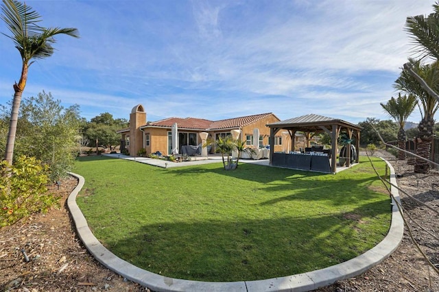 rear view of property with a patio area, a gazebo, and a lawn