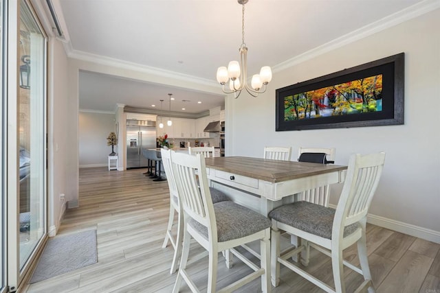 dining area featuring light hardwood / wood-style flooring, a chandelier, and ornamental molding