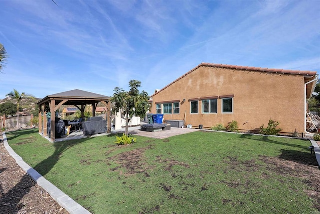 back of house with a patio area, a lawn, and a gazebo