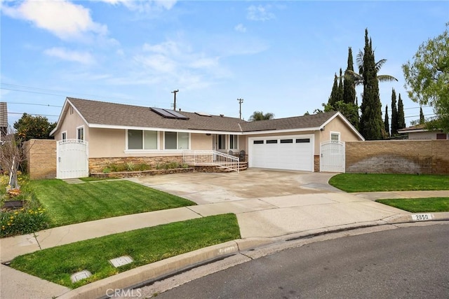 single story home with a front lawn, solar panels, and a garage