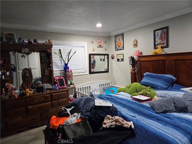 bedroom with hardwood / wood-style floors and crown molding