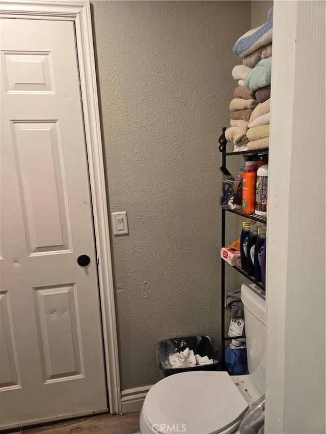 bathroom with wood-type flooring and toilet