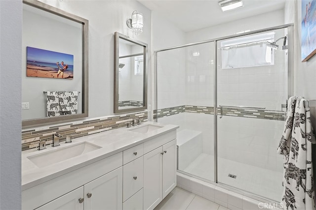 bathroom featuring tile patterned flooring, vanity, walk in shower, and decorative backsplash