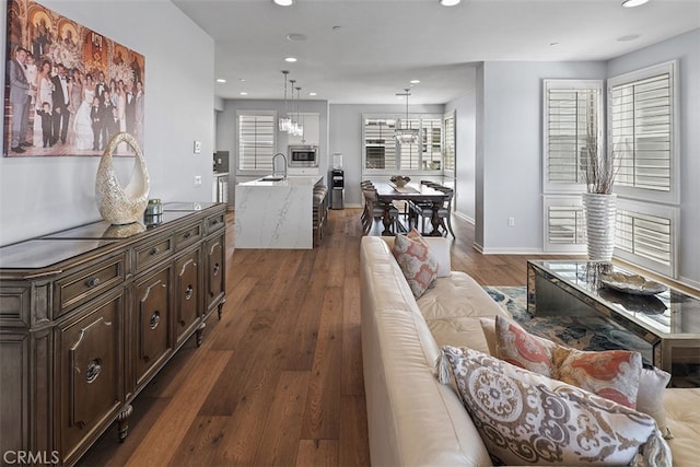 living room with sink, a wealth of natural light, and dark hardwood / wood-style flooring