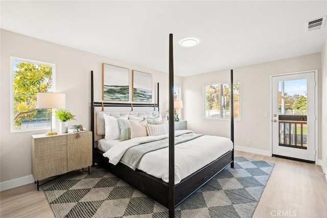 bedroom with light hardwood / wood-style floors and access to exterior