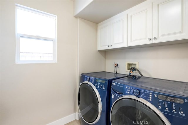 washroom featuring independent washer and dryer and cabinets