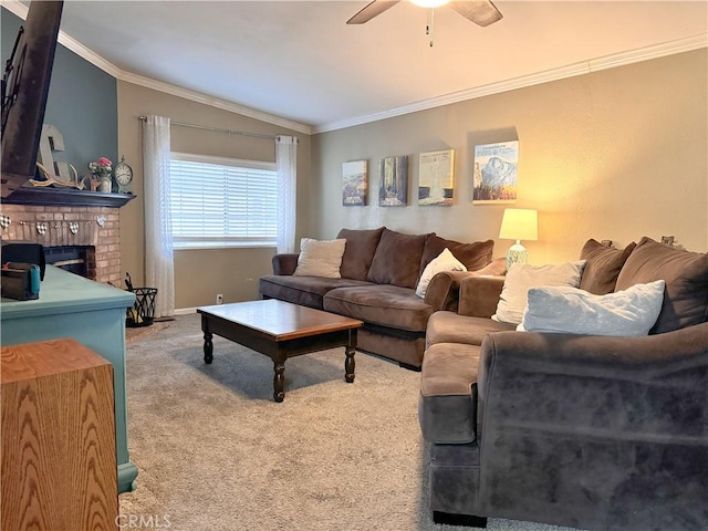 carpeted living area featuring ceiling fan, a fireplace, ornamental molding, and vaulted ceiling