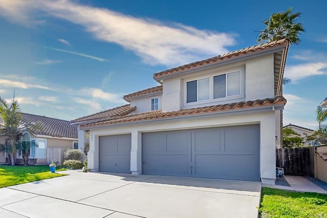 mediterranean / spanish house with a garage