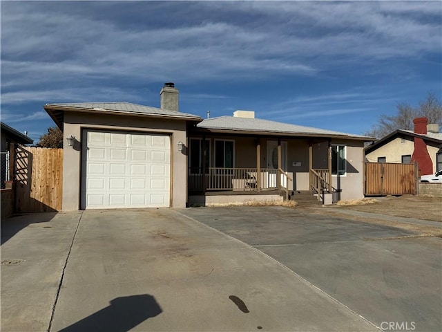 single story home featuring stucco siding, fence, concrete driveway, a garage, and a chimney