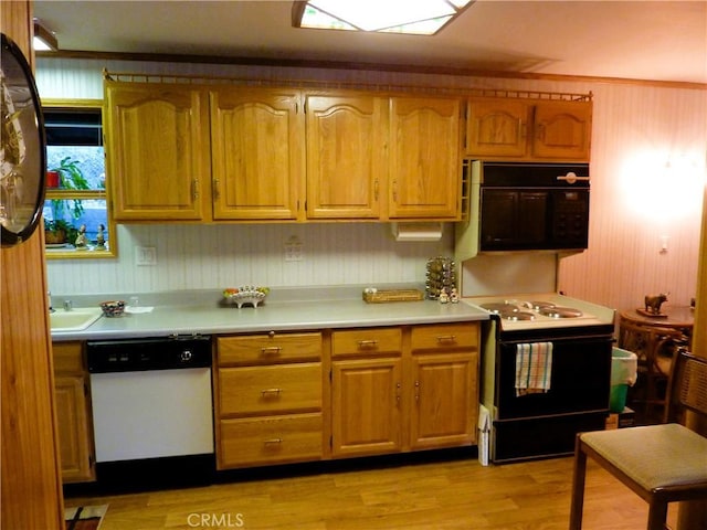 kitchen with black appliances and light hardwood / wood-style floors