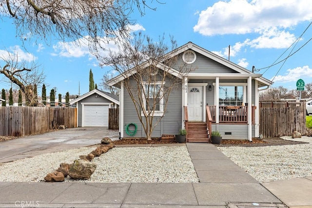 view of front of house featuring a garage, a porch, and an outdoor structure