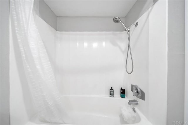 bathroom with shower / bath combination with curtain