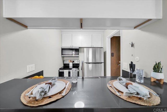 kitchen with white cabinets and appliances with stainless steel finishes