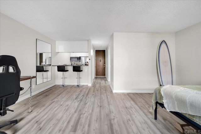 office space with light hardwood / wood-style flooring and a textured ceiling