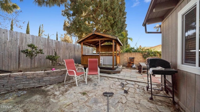 view of patio / terrace featuring a gazebo and a fenced backyard