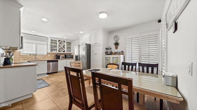 dining space featuring recessed lighting and light tile patterned flooring