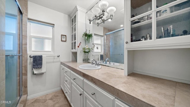 bathroom with a stall shower, tile patterned flooring, vanity, and baseboards