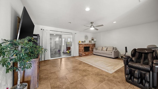 living room with a brick fireplace, a ceiling fan, and recessed lighting