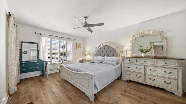 bedroom with baseboards, a ceiling fan, and wood finished floors