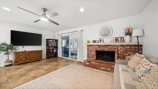 living area featuring a fireplace and ceiling fan