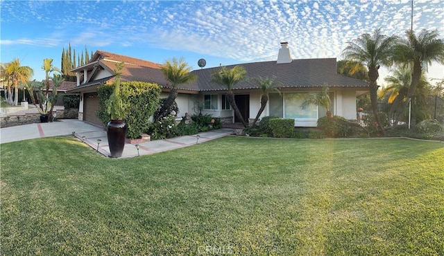 view of front of house featuring a garage, a front lawn, and concrete driveway