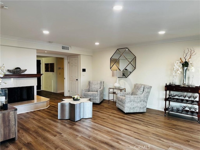 2120 E White Lantern Ln, Orange, CA 92867 - living area with crown molding, wood finished floors, baseboards, a fireplace with raised hearth, and recessed lighting