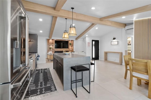 kitchen with a center island, a wall unit AC, dark countertops, open floor plan, and high end refrigerator