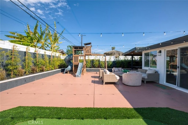 view of patio featuring an outdoor hangout area, a playground, and a fenced backyard