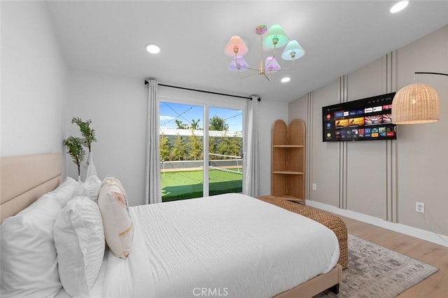 bedroom featuring access to exterior, baseboards, wood finished floors, and recessed lighting