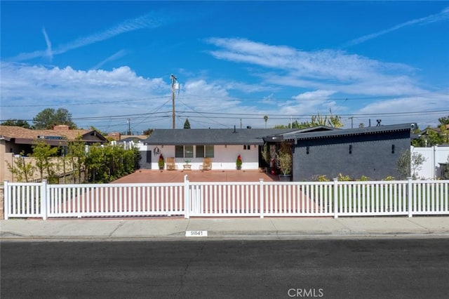 ranch-style house with a fenced front yard