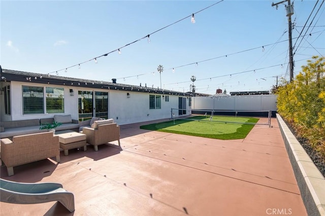 view of patio featuring fence and outdoor lounge area