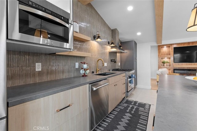 kitchen with appliances with stainless steel finishes, dark countertops, range hood, and modern cabinets