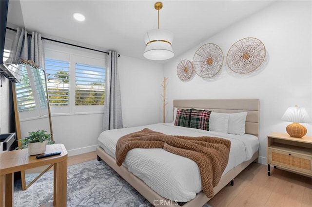 bedroom featuring recessed lighting, baseboards, and wood finished floors